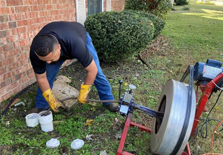 Drain Doctor technician arriving at a Dallas home for drain cleaning service